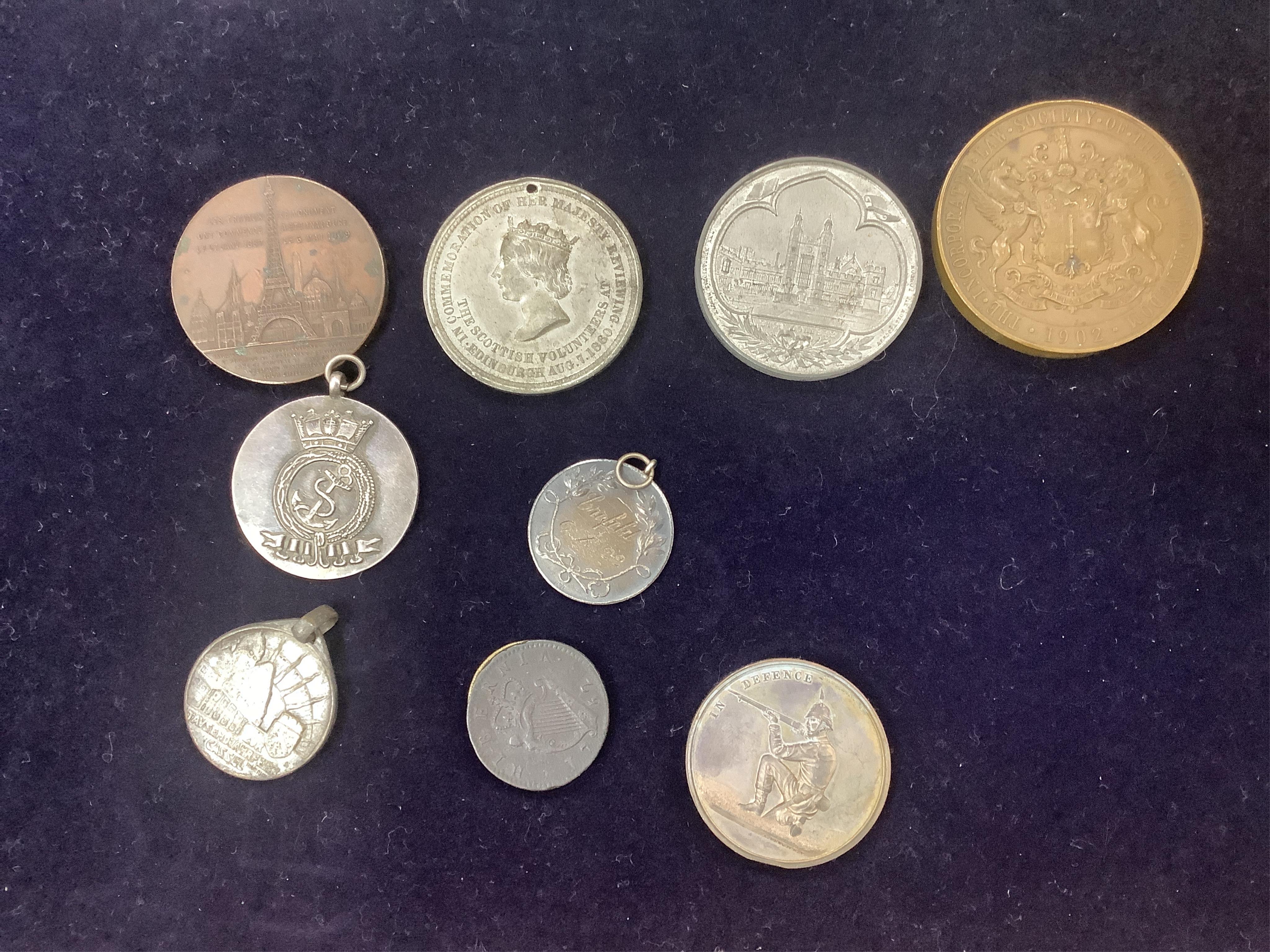 British and world commemorative medals and coins, to include Eton College white soft metal metal, 1902 Law Society incorporation bronze medal, 1889 souvenir of the Eiffel Tower bronze medal, for public service in India M